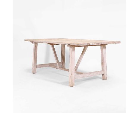A distressed pine table, of recent manufacture, Chinese, the six-plank top raised on end supports united by stretchers,200cm 