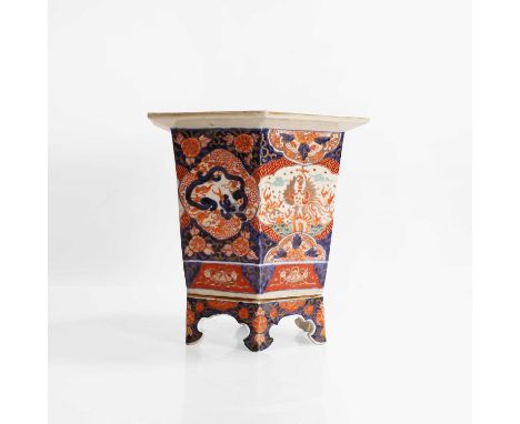 An Imari porcelain hexagonal jardinière, 19th century, Japanese, with a wide rim over tapering sides, decorated with phoenixe