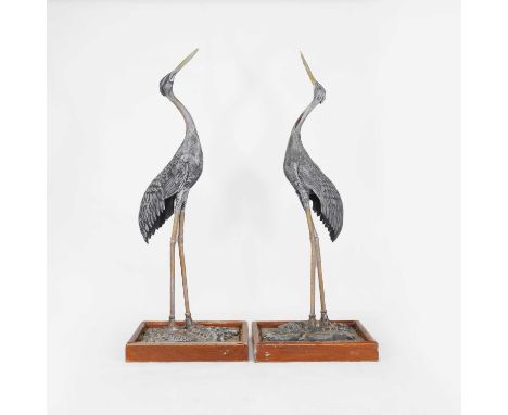 A pair of large painted garden ornaments in the form of cranes, early to mid-20th century, in the manner of H Crowther, each 