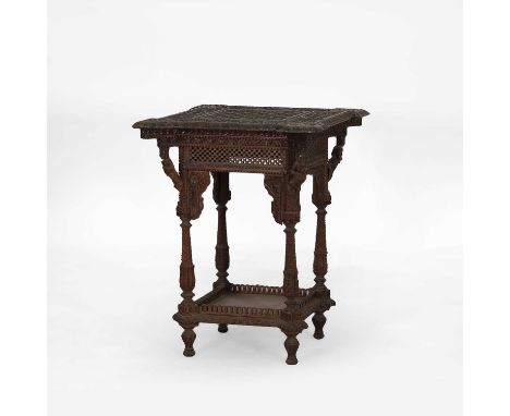A rosewood side table, c.1860, Anglo-Indian, profusely carved with a central square honeycomb and flower head panel, bordered