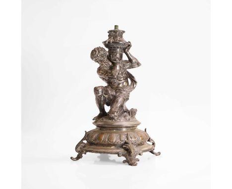 A silver-plated cast figure of Atlas, 19th century, holding an urn, part of a candelabra stand, with a circular stepped base 