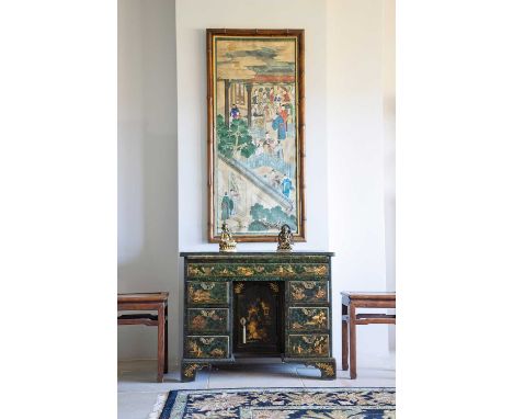 A George III japanned kneehole desk, mid-18th century, the decorated top over a leather-inset brushing slide, a single long d
