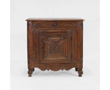 A walnut cabinet, 18th century, French, Breton, the top with a moulded edge above a single drawer carved with scrolling vine,