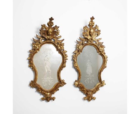 A pair of baroque-style giltwood and etched-glass wall mirrors, 19th century, North Italian, each frame with a mask crest ove