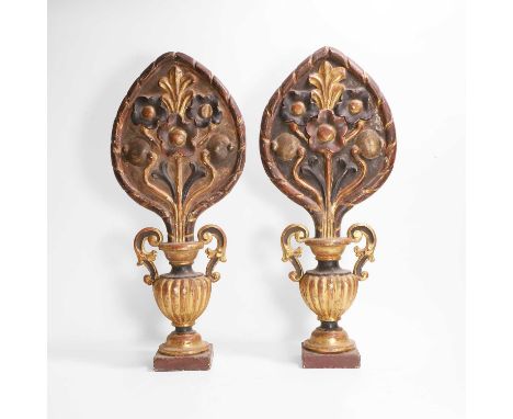 A pair of carved giltwood finials, 19th century, each with a relief-carved panel depicting a spray of flowers emanating from 