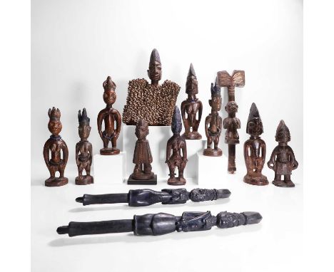 A collection of ten African carved wood figures, 20th century, the largest with a cowrie shell dress,largest 22cm wide11cm de