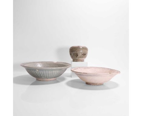 Two footed bowls, Thai, comprising a celadon-glazed bowl with incised decoration to the interior,30cm diameter9cm high, andan