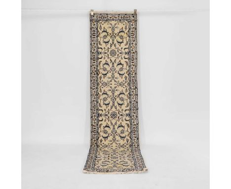 A Nain runner, Persian, the cream ground decorated with foliage and scrolls, within a banded border,294 x 70cmCondition Repor