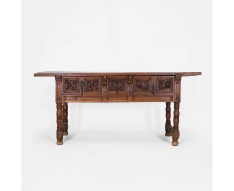 A walnut side table, late 17th/early 18th century, Spanish, the rectangular top above three frieze drawers with carved foliat