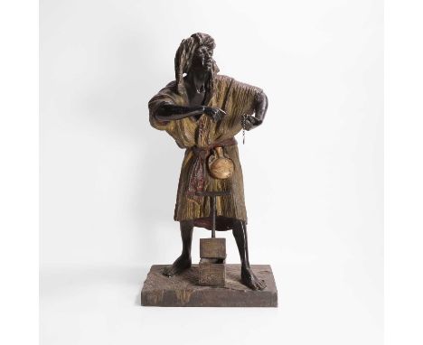 After Arthur Waagen, 20th century, a cold-painted bronze figure of a street vendor, wearing robes, holding a silver chain wit