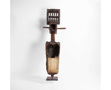 A carved wooden and hide 'dhodro banam' lute, early 20th century, Indian, Odisha, Santal people, the upper section carved and