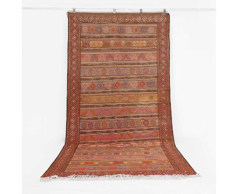 A large flat-weave wool runner, of recent manufacture, the central fields with alternating bands of geometric and foliate des