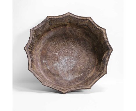 A brass basin, 12th-14th century, Persian, possibly Khorasan, the centre decorated with an incised stylised figure, surrounde