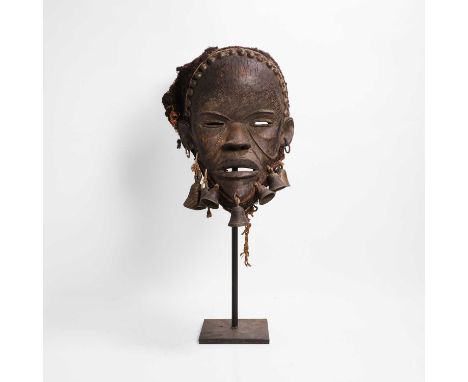 A carved hardwood mask, probably 20th century, Côte d'Ivoire, Dan people, a carved wood mask with perforated eyes and mouth, 
