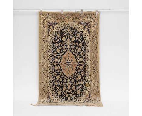A Kashan wool rug, of recent manufacture, Persian, the central blue-ground field with a medallion and scrolling foliage, with