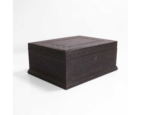 A carved ebony casket, c.1890, Anglo-Indian, decorated all over with flower heads and geometric designs,35cm wide27cm deep15c