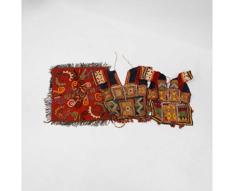 A group of textiles, 20th century, South Asian, comprising three choli blouses, variously decorated with geometric designs, 5