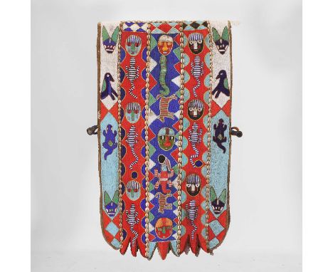 A beaded ceremonial tunic, 20th century, Nigeria, Yoruba, with glass beads and cowrie shells on a linen ground, decorated thr