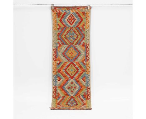 A flat-weave kilim runner, of recent manufacture, woven with repeating geometric motifs in polychrome colours,200 x 66cm