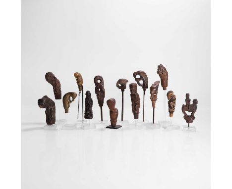 A collection of fourteen kris hilts, 18th century and later, Indonesian, to include wooden, horn, bone and metal examples, fi