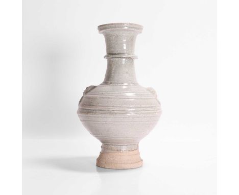 A stoneware vase, Song dynasty (960-1279), Chinese, the ovoid body rising from a tall stepped foot, decorated with concentric