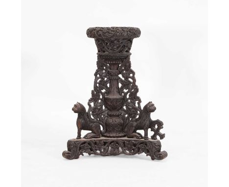A carved teak and rosewood jardinière stand, c.1860, Anglo-Indian, with an elaborately carved and pierced bowl, above an urn-