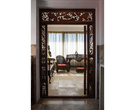 A hardwood console table,  c.1860-70, Anglo-Indian, with a pierced scrolling and foliate back, centred with a roundel with a 