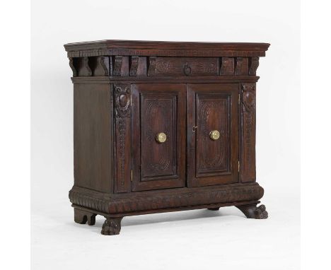A walnut and pine small side cabinet, 19th century, Tuscan, having a single drawer, over cupboard doors with central brass ha