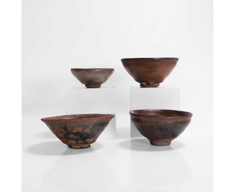A collection of four Jian ware tea bowls, Song dynasty (960-1279), each with deep rounded sides, rising from a short straight