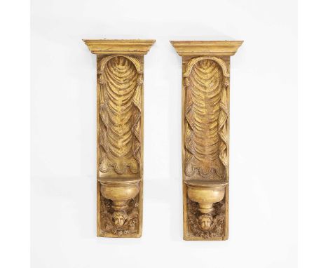 A pair of carved giltwood niches, 20th century, each carved with swagged drapery and cherub mask supports,37cm wide23cm deep1