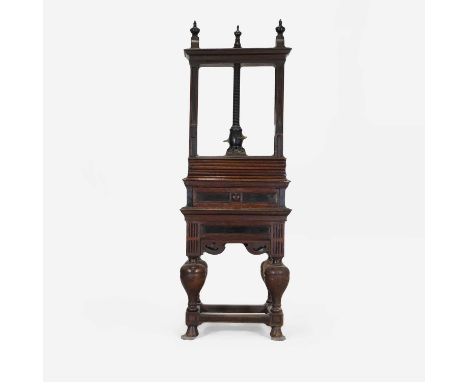 An oak and ebony-inlaid linen or book press, 18th century, the upper section with foliate-carved decoration, over a single dr