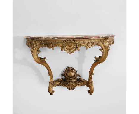 A Louis XV-style carved giltwood console table, late 18th century, the shaped Breccia Violetta top raised on a carved scrolli