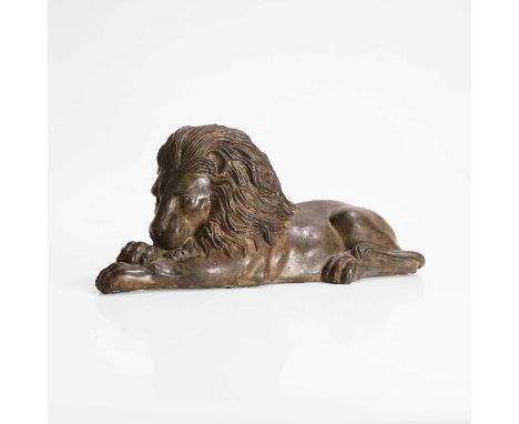 A bronze figure of a lion, 19th century, the recumbent beast with its front paws placed one on another,30cm long12cm wide13cm