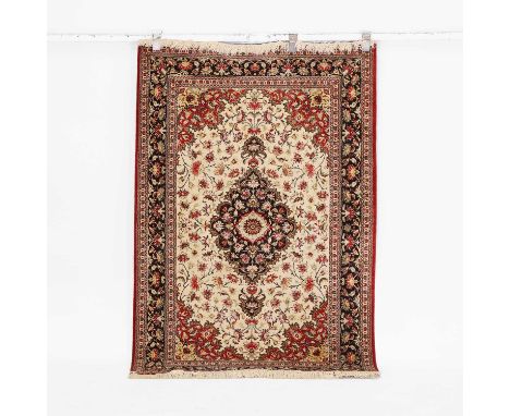A wool rug, Persian, the central cream field with a dark brown medallion, and red and yellow spandrels, within multiple folia