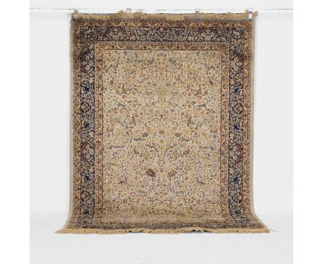 A Kerman rug, 20th century, Persian, the central cream ground decorated with animals, scrolls and foliage, within multiple fo