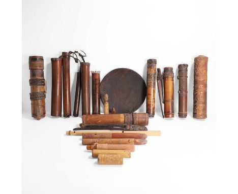 A large group of tribal items, 20th century, including dart quivers, wind chimes, a carved wood dish, a flute and other conta