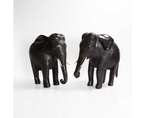 A large pair of ebony and lacquered elephants, probably 18th century, Indian, each modelled standing with a curled trunk and 