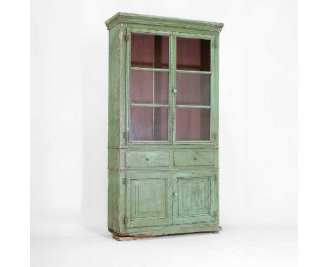 A distressed green-painted pine cabinet, late 19th century, Menorcan, with a wide moulded cornice, over glazed cupboards encl