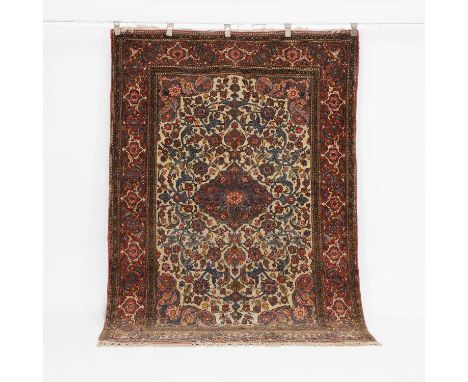 An Isfahan rug, 20th century, the central cream-ground field with scrolling foliage and a medallion, within multiple foliate 