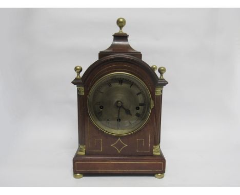 A Regency and later mahogany bracket clock of arched form with pagoda top, the case with brass inlay, ball finials and bun fe