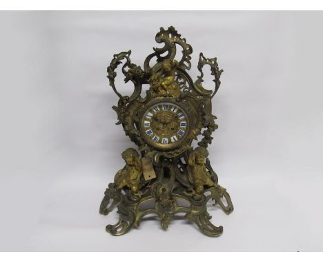 A large decorative 19th Century French ormulu table clock, the case with many rococo scrolls, fruit and rose motifs and three