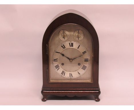 An Edwardian mahogany arch top mantel clock with silvered dial and Roman chapter ring, german striking and chiming movement, 