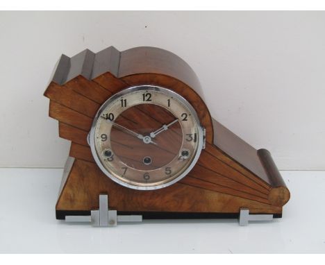 A 1930's walnut Art Deco striking and chiming mantel clock with silvered Arabic chapter ring, key and pendulum, 23cm high