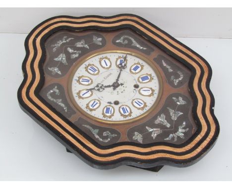 A late 19th/ early 20th Century French ebonised dial clock of shaped form, the bezel surrounded by mixed hardwood and mother 