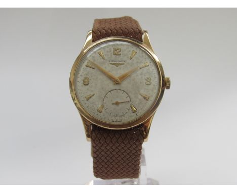 LONGINES: a 1950's 9ct gold cased gent's wristwatch with manual wind movement, silvered dial (foxed) with subsidiary seconds,