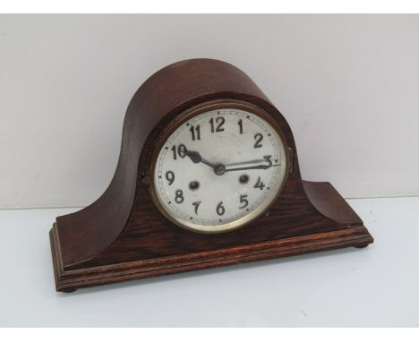An early 20th Century oak Napoleon hat striking mantel clock, key and pendulum, 23cm high 
