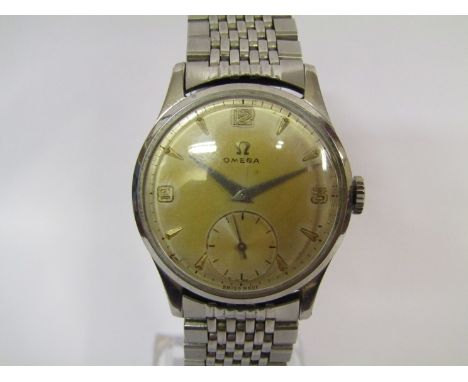 OMEGA: A stainless steel cased gent's wristwatch with Omega steel bracelet and clasp, silvered discoloured dial with subsidia