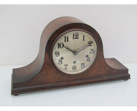 An early 20th Century oak Napoleon hat striking and chiming mantel clock, key and pendulum, 23cm high