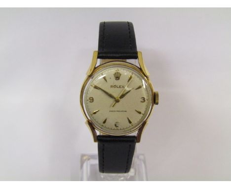 ROLEX: A 9ct gold cased gent's wristwatch with silvered engine turned dial with manual wind movement, ref. 28065, circa 1955,