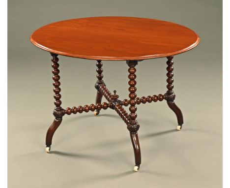 A Victorian mahogany oval centre table, with twist turned supports, low turned stretchers and legs terminating in ceramic cas